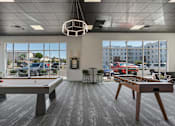 Thumbnail 27 of 42 - A room with a pool table and a foosball table. 605 Place Student Housing & Co-Living, St George, UT