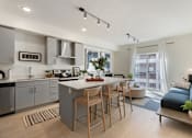 Thumbnail 6 of 25 - A modern kitchen with a dining area and a living room.