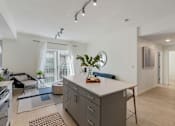 Thumbnail 4 of 25 - A modern kitchen with a large island and a dining area.