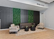 Thumbnail 36 of 62 - A living room with a couch, chairs, and a green wall.