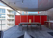 Thumbnail 53 of 62 - A patio with a table and chairs under a white canopy.