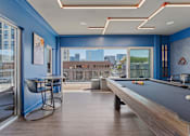 Thumbnail 3 of 62 - A room with a pool table and a chair.