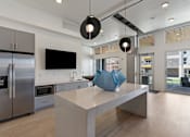 Thumbnail 10 of 62 - A modern kitchen with a large island and stainless steel appliances.