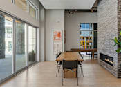 Thumbnail 45 of 62 - A room with a table and chairs and a fireplace.