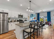 Thumbnail 1 of 26 - A modern kitchen with a large island and stainless steel appliances. at The Revival, Salt Lake City, 84101