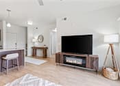 Thumbnail 5 of 26 - A modern living room with a flat screen TV and a fireplace.
