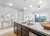 Thumbnail 9 of 26 - A modern kitchen with a large island and a view of the city.