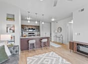 Thumbnail 6 of 26 - A modern kitchen with a bar area and a dining table.