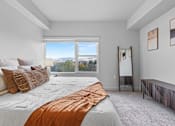 Thumbnail 16 of 26 - A bedroom with a large bed and a view of the mountains through the window.