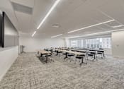 Thumbnail 7 of 19 - A conference room with a long table and chairs.