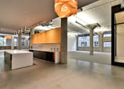Thumbnail 12 of 25 - A large room with a white table and orange sculpture.
