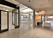 Thumbnail 6 of 25 - A modern interior space with a glass door and a white counter.