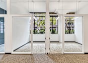Thumbnail 10 of 25 - A white door with a glass window is open.
