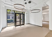Thumbnail 14 of 25 - A white room with three circular light fixtures hanging from the ceiling.