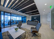 Thumbnail 22 of 24 - A modern office space with a glass wall and a reception desk.