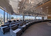 Thumbnail 13 of 24 - A conference room with grey chairs and a carpeted floor.