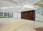 Thumbnail 15 of 15 - A room with a brown wall and wooden floor.
