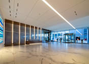 Thumbnail 18 of 24 - A large, modern hallway with marble floors and a colorful mural on the wall.