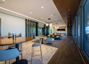 Thumbnail 21 of 24 - A modern dining area with a long table and chairs.