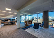 Thumbnail 5 of 24 - A modern office space with a view of the city skyline.