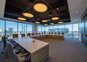 Thumbnail 6 of 24 - A conference room with a long table and chairs, and a view of the city outside the windows.