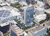 Thumbnail 18 of 18 - A cityscape with a large building featuring a solar panel on its roof.