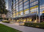 Thumbnail 8 of 18 - The image shows a modern building with a glass facade and a sign that reads "The Steps".