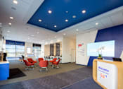 Thumbnail 12 of 18 - A reception area with a blue and white color scheme and a welcome sign.
