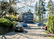 Thumbnail 8 of 8 - A car is driving down a road past a building with a sign that says "Liberty View.".