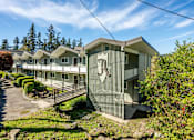 Thumbnail 8 of 8 - A row of houses with a stone wall in front.