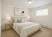 Thumbnail 3 of 8 - A bedroom with a large bed and a painting on the wall.