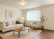 Thumbnail 5 of 8 - A living room with a couch, chair, and table.