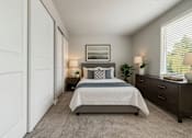 Thumbnail 2 of 8 - A bedroom with a bed, nightstands, and a window with blinds.