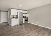 Thumbnail 4 of 8 - A kitchen with a refrigerator, oven, and sink.