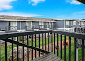 Thumbnail 6 of 8 - A balcony overlooks a grassy area and a baseball diamond.