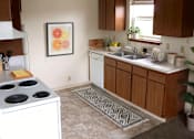 Thumbnail 1 of 8 - A kitchen with a stove top oven and a sink.