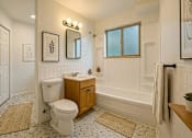 Thumbnail 6 of 8 - A white toilet is in a bathroom with a window.