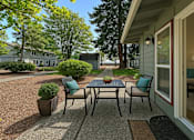 Thumbnail 5 of 8 - A patio with a table and chairs is shown.