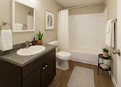 Thumbnail 2 of 8 - A bathroom with a white toilet and a white shower curtain.