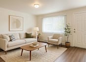 Thumbnail 5 of 8 - A living room with a couch, chair, and table.