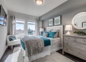 Thumbnail 5 of 8 - Lux Apartments Bellevue spacious bedroom with large windows, a queen-sized bed, side table and dresser with extra room to walk around the bed