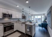 Thumbnail 8 of 8 - All Lux kitchen and living room spaces include stainless steel appliances, including dishwasher and overhead microwave/exhaust as well as built-in air conditioning