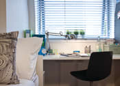 Thumbnail 3 of 8 - a desk with a chair in front of a window