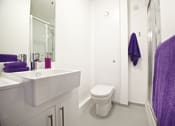 Thumbnail 5 of 8 - a bathroom with a sink toilet and a shower