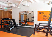 Thumbnail 13 of 16 - A gym with a sign that says "Feel the Burn".