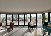 Thumbnail 6 of 19 - a living room with a view of the city