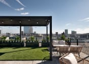 Thumbnail 13 of 19 - a view of the city from a roof top terrace with chairs and grass