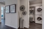 Thumbnail 3 of 8 - Lux Apartments Bellevue WA laundry room with front loading washer and dryer included and some added storage space