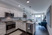 Thumbnail 1 of 8 - All Lux kitchen and living room spaces include stainless steel appliances, including dishwasher and overhead microwave/exhaust as well as built-in air conditioning