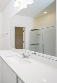 a bathroom with a large mirror and two sinks